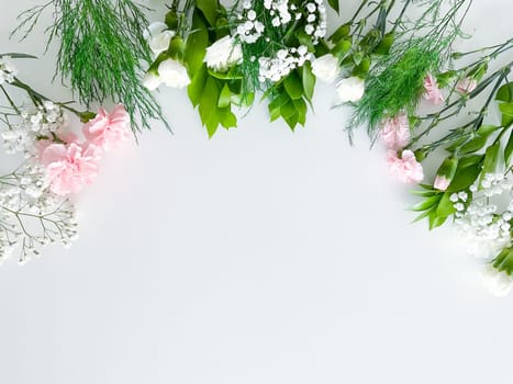 Close up photo of a bouquet of pink and white carnations isolated on a white background. With empty space for text or inscription. For postcard, advertisement or website.