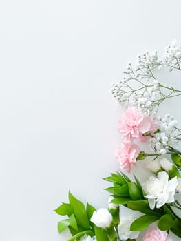 Close up photo of a bouquet of pink and white carnations isolated on a white background. With empty space for text or inscription. For postcard, advertisement or website.