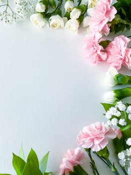 Close up photo of a bouquet of pink and white carnations isolated on a white background. With empty space for text or inscription. For postcard, advertisement or website.