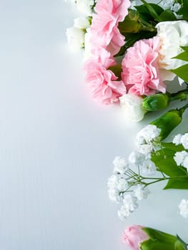 Close up photo of a bouquet of pink and white carnations isolated on a white background. With empty space for text or inscription. For postcard, advertisement or website.