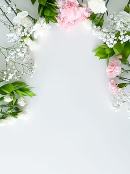 Close up photo of a bouquet of pink and white carnations isolated on a white background. With empty space for text or inscription. For postcard, advertisement or website.