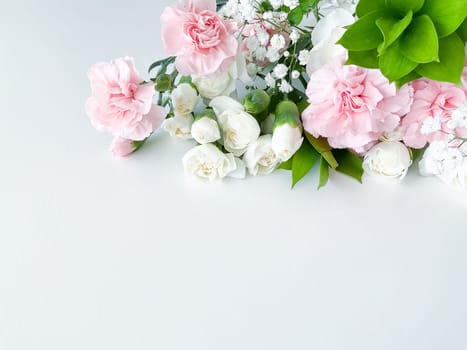 Close up photo of a bouquet of pink and white carnations isolated on a white background. With empty space for text or inscription. For postcard, advertisement or website.