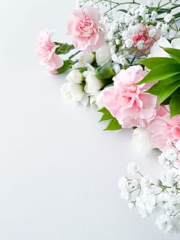 Close up photo of a bouquet of pink and white carnations isolated on a white background. With empty space for text or inscription. For postcard, advertisement or website.