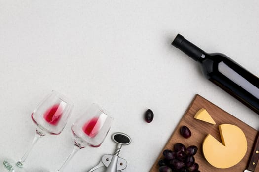 Wine, glasses and corkscrew over white background. Top view with copy space