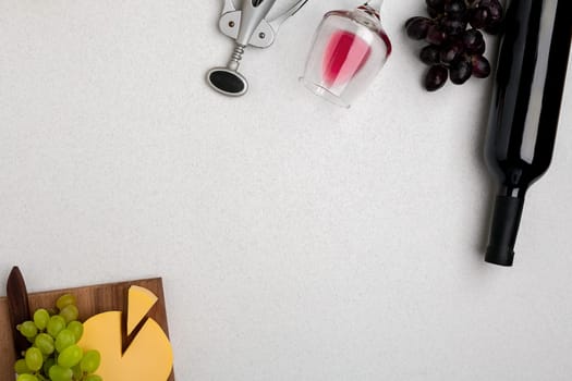 Wine, glasses and corkscrew over white background. Top view with copy space