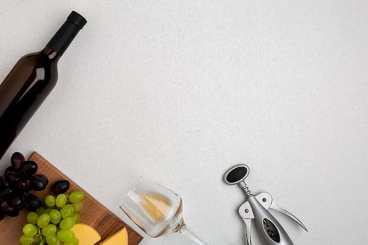 Wine, glasses and corkscrew over white background. Top view with copy space