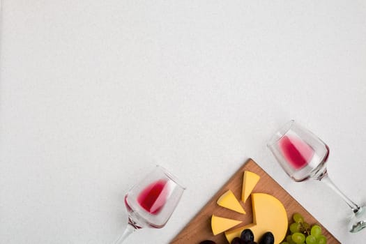 Glasses with red wine on white background from top view. Copy space
