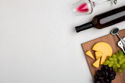 Wine, glasses and corkscrew over white background. Top view with copy space