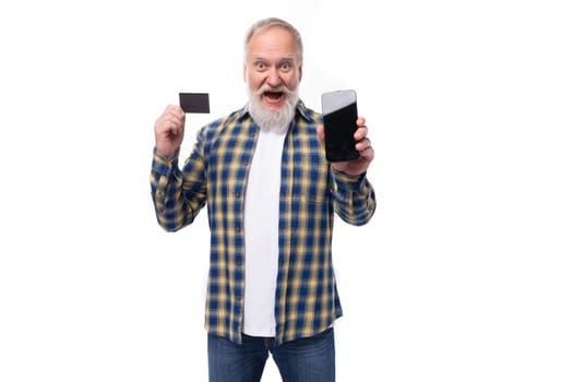handsome elderly gray-haired retired man with mustache and beard with card and phone mockup.