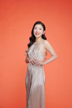 Portrait of a beautiful elegant woman in an evening long dress with sequins