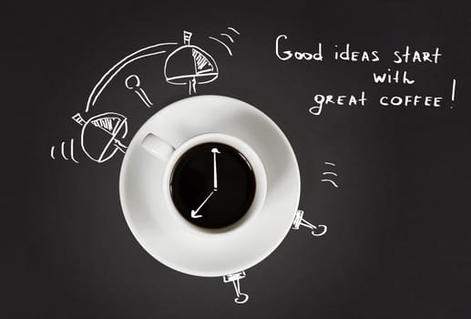 Good morning coffee and alarm clock concept on black slate background, top view