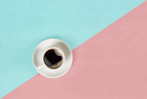 A cup of black coffee on blue and pink background. View from above. Still life. Mock up. Flat lay. Copy space