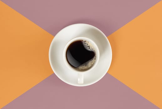 A cup of black coffee on orange and red background. View from above. Still life. Mock up. Flat lay. Copy space