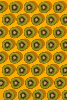 Colorful pattern of kiwi. Top view of the sliced kiwi. Kiwi on a yellow background