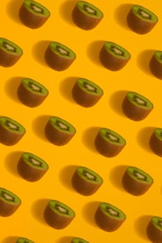 Colorful pattern of kiwi. Top view of the sliced kiwi. Kiwi on a yellow background