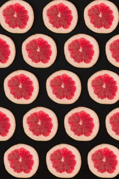 Grapefruit pattern isolated on black background. Flat lay. Print