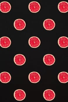 Grapefruit pattern isolated on black background. Flat lay. Print