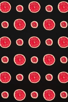 Grapefruit pattern isolated on black background. Flat lay. Print