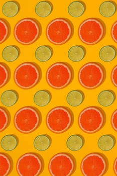 Grapefruit and lime pattern on yellow background. Minimal flat lay concept. Print