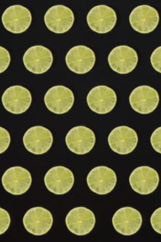 Lime pattern on black background. Minimal flat lay concept. Print