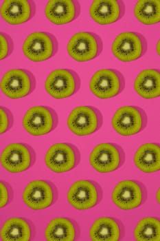 Pattern of kiwi. Top view of the sliced kiwi on pink background. Minimal flat lay concept. Print