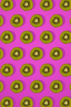 Pattern of kiwi. Top view of the sliced kiwi on pink background. Minimal flat lay concept. Print