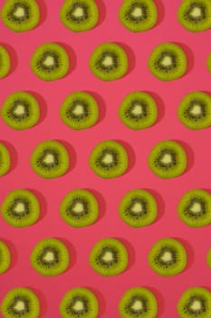 Pattern of kiwi. Top view of the sliced kiwi on pink background. Minimal flat lay concept. Print