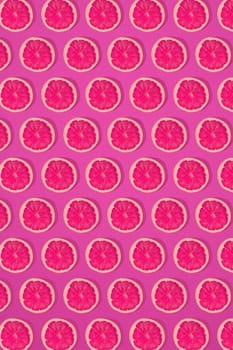 Grapefruit pattern on pink background. Minimal flat lay concept. Print