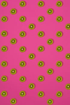 Pattern of kiwi. Top view of the sliced kiwi on pink background. Minimal flat lay concept. Print