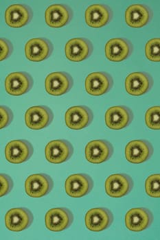 Pattern of kiwi. Top view of the sliced kiwi on blue background. Minimal flat lay concept. Print
