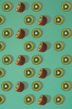 Pattern of kiwi. Top view of the sliced kiwi on blue background. Minimal flat lay concept. Print