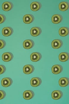 Pattern of kiwi. Top view of the sliced kiwi on blue background. Minimal flat lay concept. Print