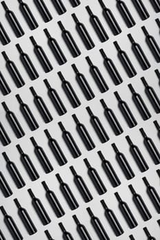 Dark wine bottles. Creative dark and textured abstract background. A lot of bottles of wine on a white background. Pattern