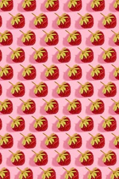 Colourful bright pattern with ripe strawberry. Top view. Pink background. Copy space. Flat lay