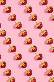 Colourful bright pattern with ripe strawberry. Top view. Pink background. Copy space. Flat lay