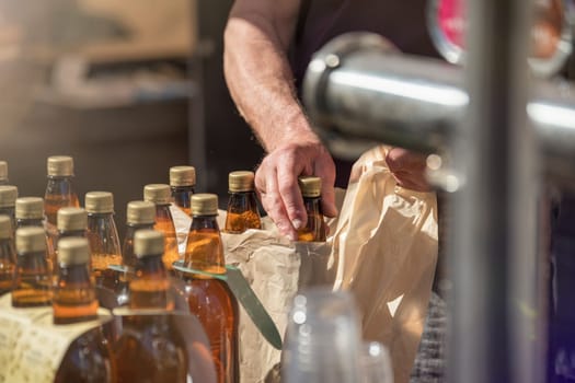 Craft beer vendor packaging beer bottles for a customer. The concept of a small business for the production of beer. Copy space