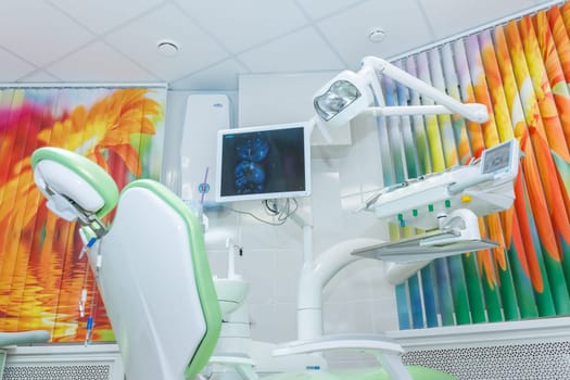 Modern dental office with chair and professional computer anesthesia system