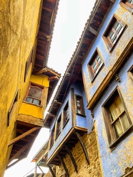 Cumalikizik village is a 700 years old Ottoman village in Turkey. Old Ottoman village in Bursa city, Turkey. Narrow street with old Ottoman houses and turkish flag