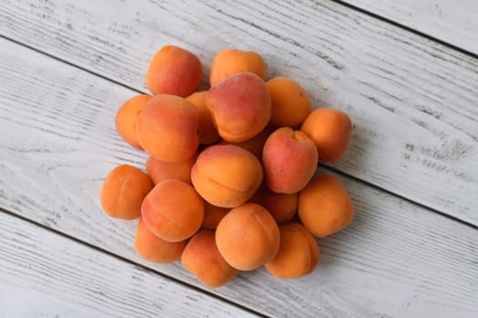 Ripe apricot on wooden background