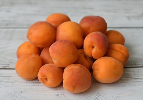 Ripe apricot on wooden background