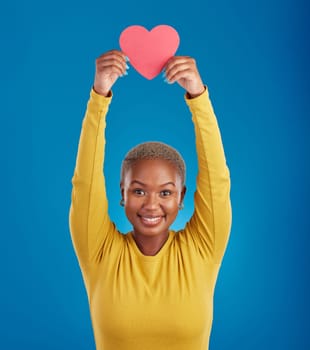 Paper, heart and portrait of black woman in studio for love, date and kindness. Invitation, romance and feelings with female and shape isolated on blue background for emotion, support or affectionate.