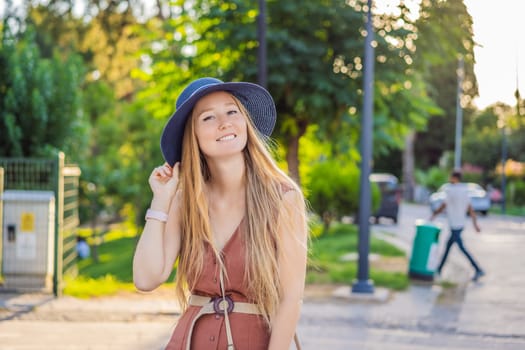 Happy woman tourist on background of old street of Antalya. female tourist traveler discover interesting places and popular attractions and walks in the old city Kalechi of Antalya, Turkey. Turkiye.