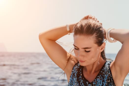 Woman travel sea. Young Happy woman in a long red dress posing on a beach near the sea on background of volcanic rocks, like in Iceland, sharing travel adventure journey