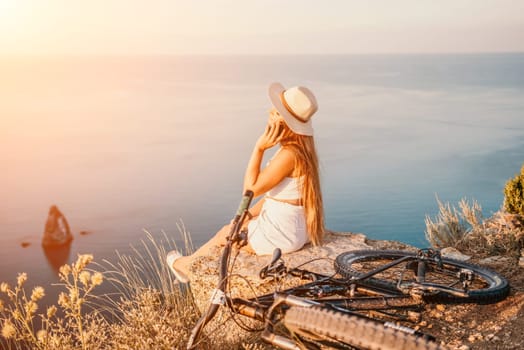 Woman travel sea. Young Happy woman in a long red dress posing on a beach near the sea on background of volcanic rocks, like in Iceland, sharing travel adventure journey