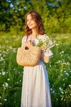 beautiful woman laughing in nature in a chamomile field holding a wicker basket in her hands. High quality photo