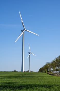 Modern wind turbines in front of a blue sky in Germany