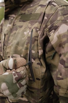 Preparing for Combat: Close-up of Soldier Putting on Gear in the Field