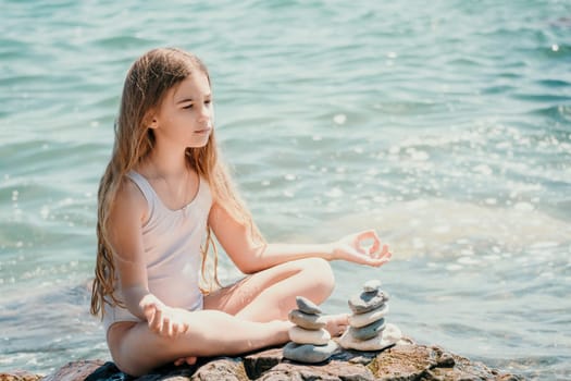 Balanced Pebbles Pyramid on the Beach on Sunny Day and Clear Sky at Sunset. Blue Sea on Background Selective focus, zen stones on sea beach, meditation, spa, harmony, calm, balance concept.