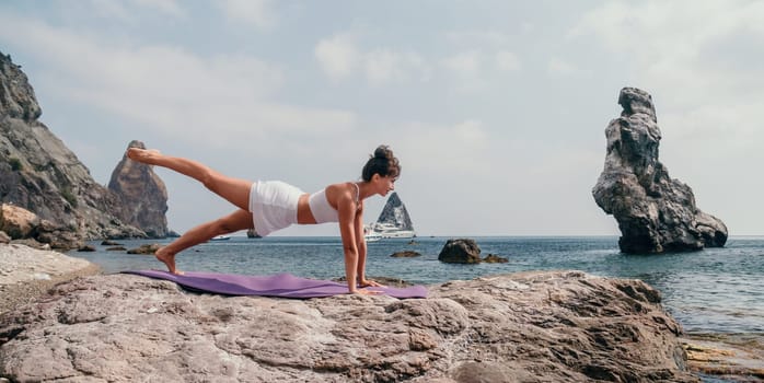 Fitness woman sea. Outdoor workout on yoga mat in park near to ocean beach. Female fitness pilates yoga routine concept. Healthy lifestyle. Happy fit woman exercising with rubber band in park.