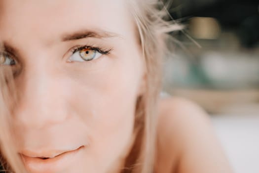 Happy woman portrait in cafe. Boho chic fashion style. Outdoor photo of young happy woman with long hair, sunny weather outdoors sitting in modern cafe